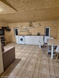 a large kitchen and dining room with a table and chairs at Modern Apartment Near Sevan Lake in Sevan