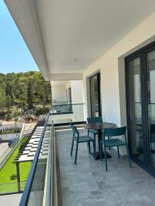 a balcony with a table and chairs on it at Amfora-modern apartments with pool in Makarska