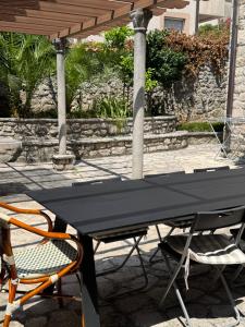 a black picnic table with two chairs under a gazebo at Villa#12 in Savina