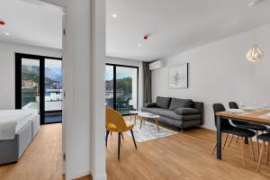 a bedroom and living room with a bed and a table at Amfora-modern apartments with pool in Makarska