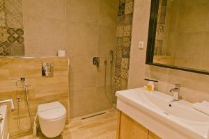 a bathroom with a shower and a toilet and a sink at Hotel Hills in Donji Štoj +5 photos