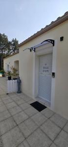 a garage with a garage door with a sign on it at Chambre la Belle Étape in Martinet +1 photo
