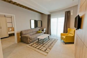 a living room with a couch and a table at Hotel Hills in Donji Štoj