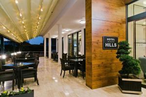 a restaurant with tables and chairs and a sign that reads work miracles at Hotel Hills in Donji Štoj