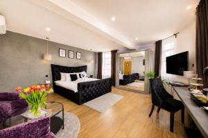 a living room with a bed and a couch at Villare Hotel Leicester City Centre in Leicester