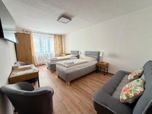 a living room with two couches and a couch at Apartmánový byt Flower in Kadaň
