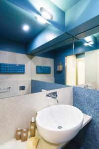 a bathroom with a sink and a blue ceiling at The Seven Mansions in Genoa +55 photos