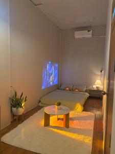 a room with a bed and a table in it at HuếDuo Homestay in Thôn Trường Giang