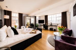 a living room with a couch and a table at Villare Hotel Leicester City Centre in Leicester +27 photos