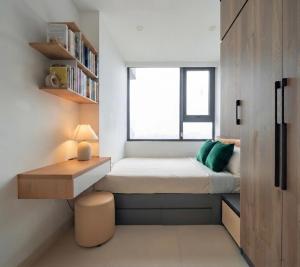 a small bedroom with a bed and a window at Ina apartment - Nera garden Hue in Hue +23 photos