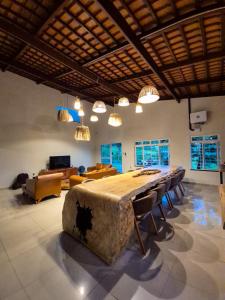 a large room with a large table with chairs at Sítio Quinta da Serra in Guaramiranga