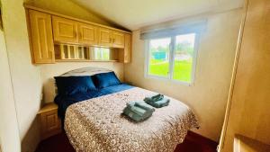 a small bedroom with a bed and a window at The Hidden Meadow in Ballybofey