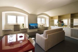 a living room with a couch and a table at The Seven Mansions in Genoa