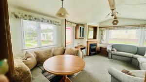 a living room with a couch and a table at The Hidden Meadow in Ballybofey