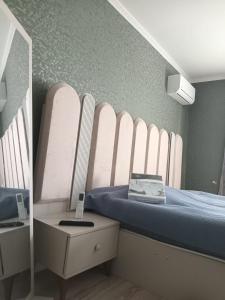 a small bedroom with a bed with a mirror at Chakvi hotel in Chakvi