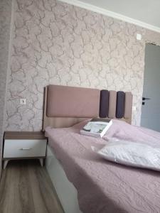 a bedroom with a pink bed with a mirror at Chakvi hotel in Chakvi +5 photos