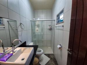 a bathroom with a shower and a sink and a toilet at Sítio Quinta da Serra in Guaramiranga +32 photos