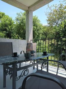 a table on a patio with two cups on it at Chakvi hotel in Chakvi