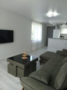 a living room with a couch and a table at Chakvi hotel in Chakvi