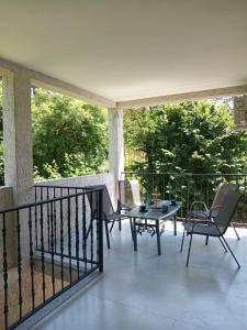 a patio with a table and chairs on a balcony at Chakvi hotel in Chakvi