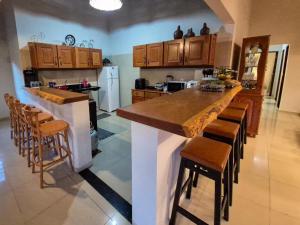 a kitchen with a large island in the middle of a room at Sítio Quinta da Serra in Guaramiranga