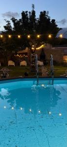 a swimming pool at night with lights in a yard at Ca L'Esquelleta casa rural by El Secret de la Conca in Vilavert