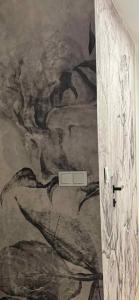 a bathroom with a painting on the wall at Kawalerka in Malbork