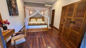 a bedroom with a bed with a canopy at ABG Villas - Agrowisata Amed in Amed +76 photos
