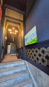 a building with stairs and a tv on the wall at Hi bed & breakfast Liège in Liège