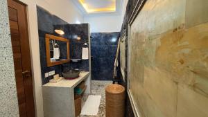 a bathroom with a sink and a mirror at ABG Villas - Agrowisata Amed in Amed