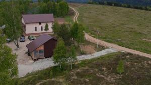 an aerial view of a small house in a field at Little H Family in Dealu Mare