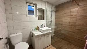 a bathroom with a toilet and a sink at Little H Family in Dealu Mare