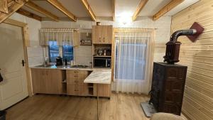 a kitchen with wooden cabinets and a stove at Little H Family in Dealu Mare