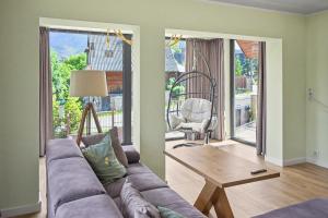 a living room with a couch and a table at Apartamenty Widokowe Pod Lasem in Kościelisko