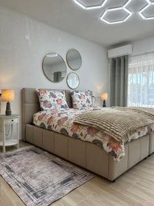a bedroom with a large bed and a mirror at Apartman NOA in Novska