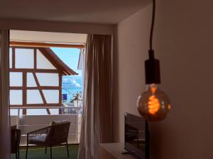 a living room with a window and a table and a lamp at Lakeside No 9 in Hagnau