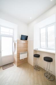 a room with two stools and a window at Mini Apartment on Kulisha 29-3 in Lviv