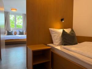 a small room with two beds and a window at Lakeside No 9 in Hagnau