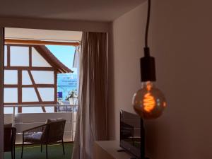a living room with a window and a pendant light at Lakeside No 9 in Hagnau +21 photos