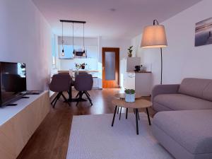 a living room with a couch and a table at Lakeside No 9 in Hagnau