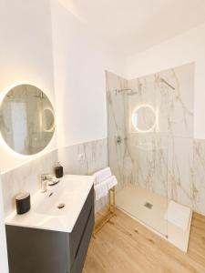 a white bathroom with a sink and a shower at Casa Granata in Caserta +9 photos