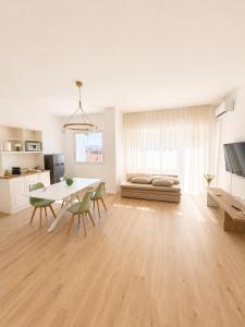 a white living room with a table and a couch at Casa Granata in Caserta