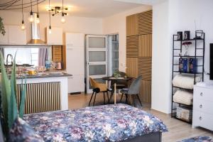 a room with a bed and a kitchen with a table at Apartman NOA in Novska