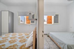 a white bedroom with a bed and two windows at Finca La Pampa in Arafo +92 photos