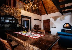 a living room with a wooden table and a couch at HANUL BUCOVINEI in Câmpulung Moldovenesc