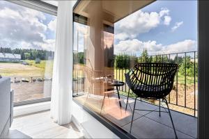 a balcony with a chair sitting on a balcony at Apartmány Krušec by Mountain ways in Plešivec