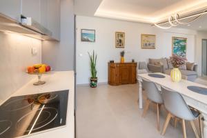 a kitchen and living room with a table and chairs at Aegean Whispers in Agios Fokas
