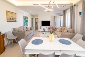 a living room with a white table and chairs at Aegean Whispers in Agios Fokas