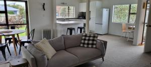 a living room with a couch and a kitchen at Point Wells Village Bach in Omaha