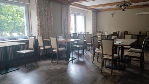 a dining room with tables and chairs and a window at Breitenfelderhof in Breitenfeld an der Rittschein